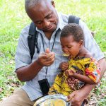 Medi Kanda Feeds Child